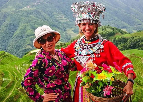 People wearing decorative dress in a green mountain landscape