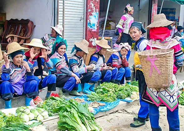 People and fresh vegetables at a local market in Yunnan