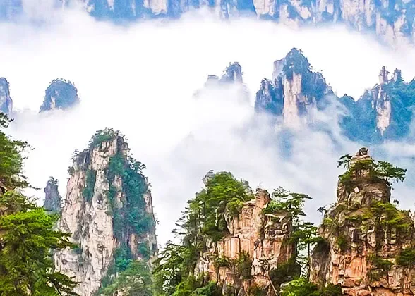 Tall sandstone peaks rising through mist